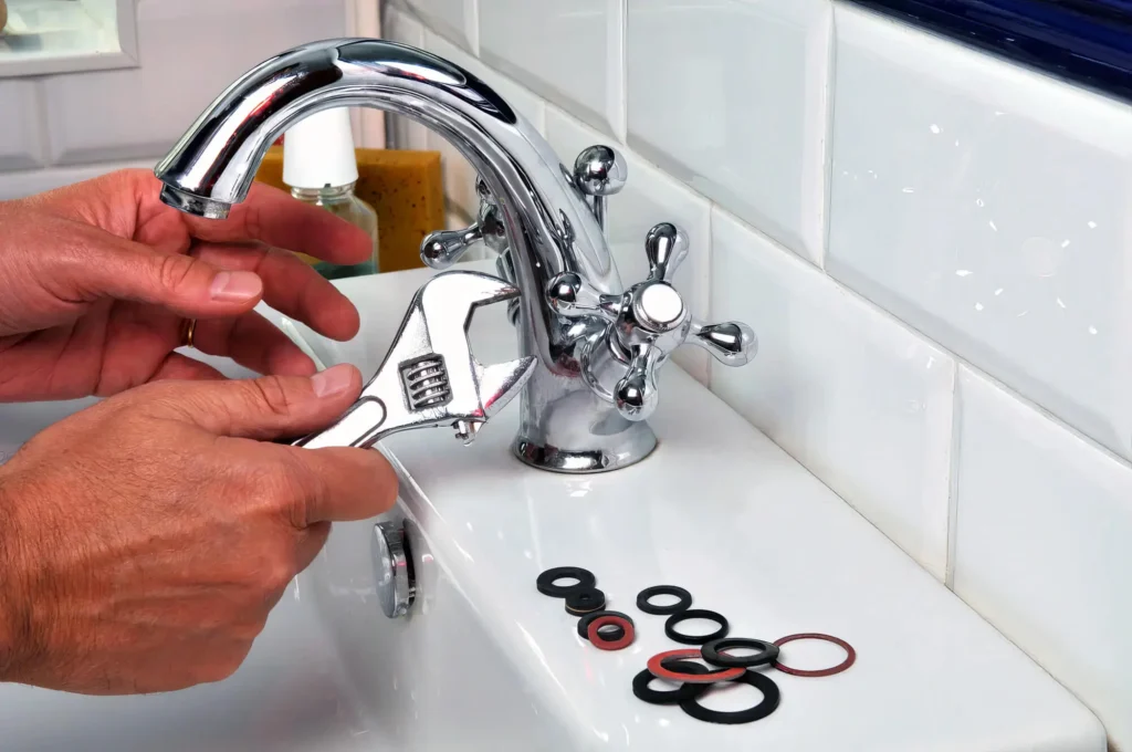 Plumber performing maintenance on a bathroom faucet in Pompano Beach
