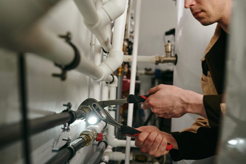 Plumbers maintaining commercial plumbing pipes in Pompano Beach