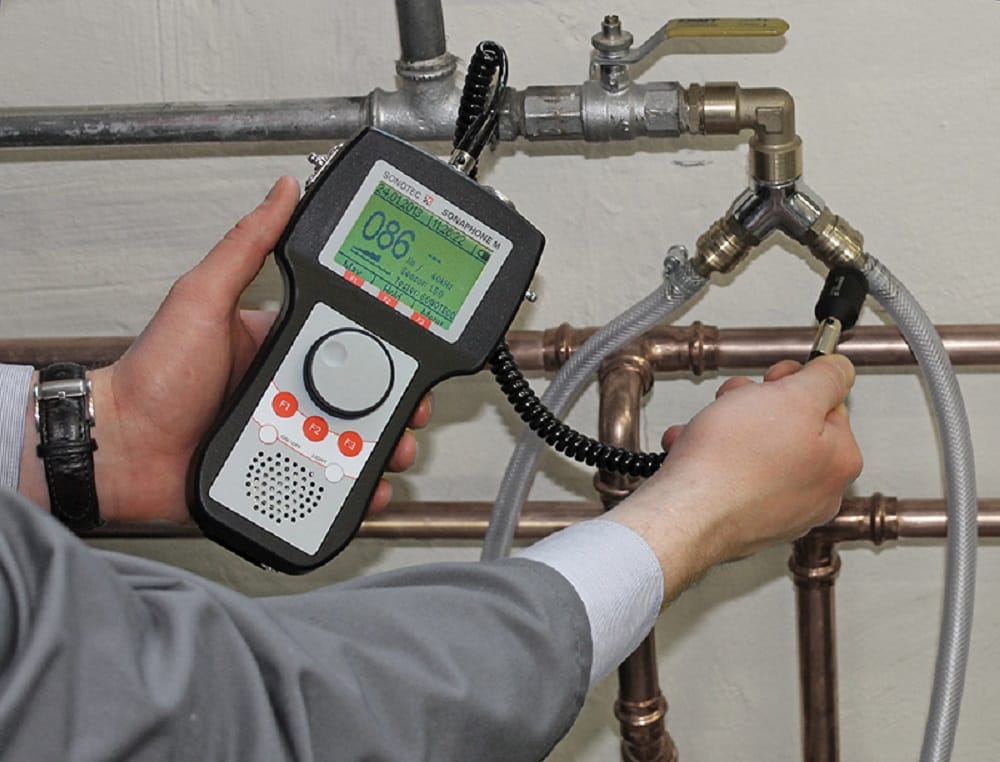 Plumber testing pipes with electronic leak detection equipment in Pompano Beach