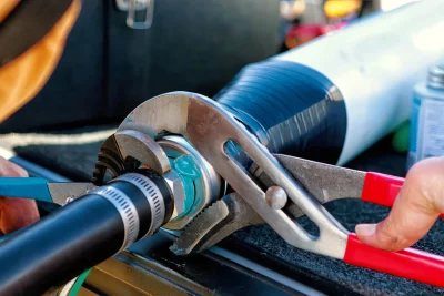Technician tightening an industrial pipe connection in Pompano Beach