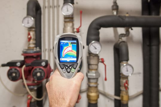 Plumber using a thermal imaging camera to inspect pipes in Pompano Beach