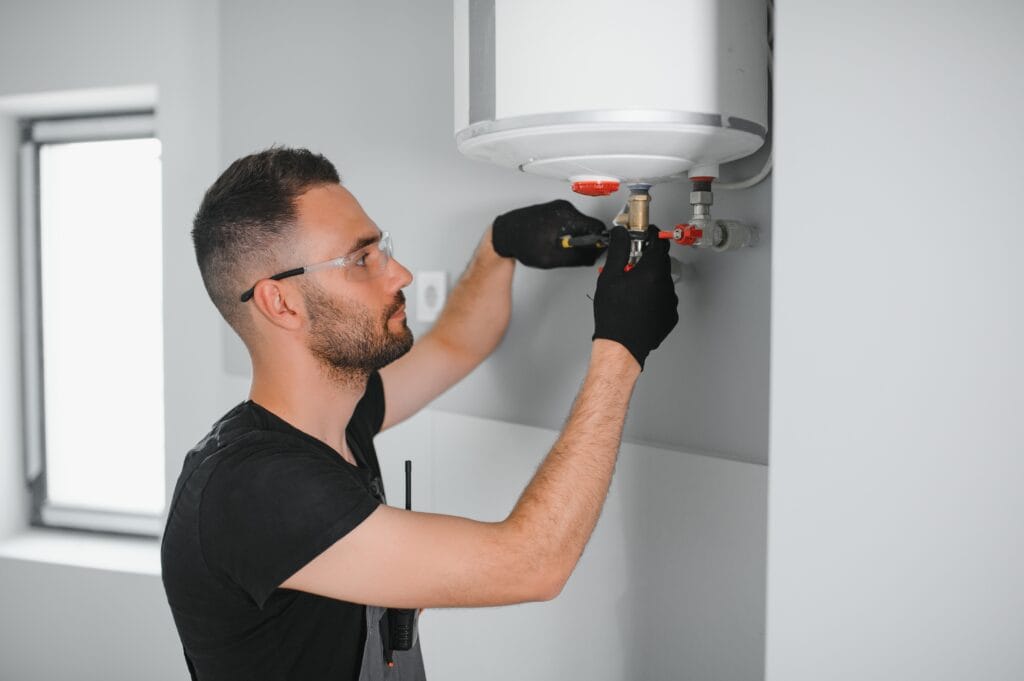 Technician performing water heater maintenance in Pompano Beach
