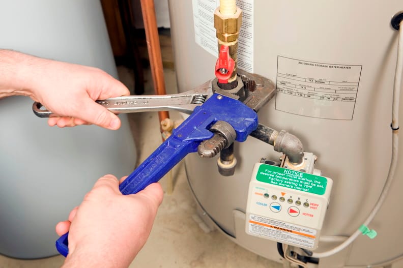 Plumber repairing a water heater valve in Pompano Beach